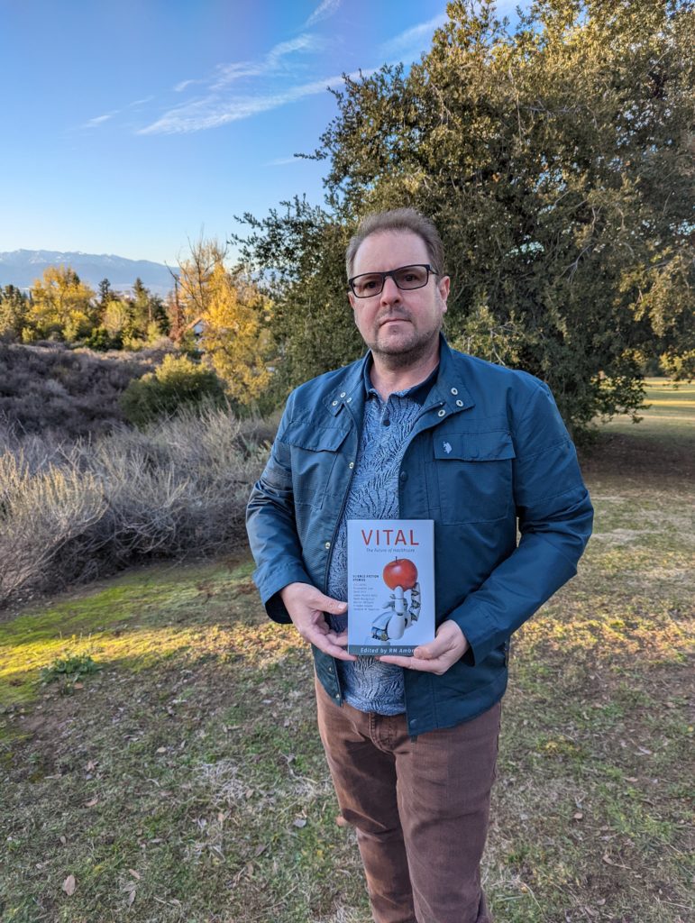 RM Ambrose holding book