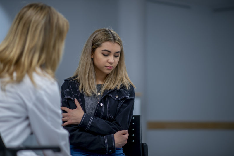 Doctor consults her teenage patient